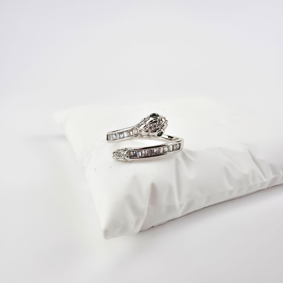 Platinum-plated snake ring with green eyes and white baguette cubic zirconia