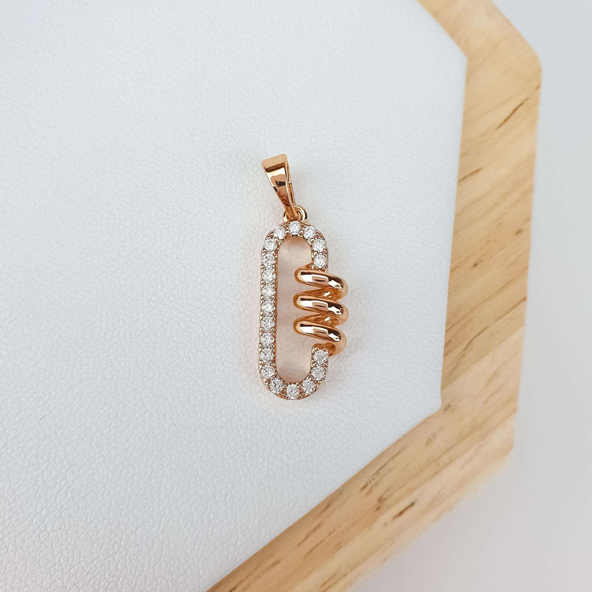 Oval cubic zirconia pendant with a spiral centre on light leather