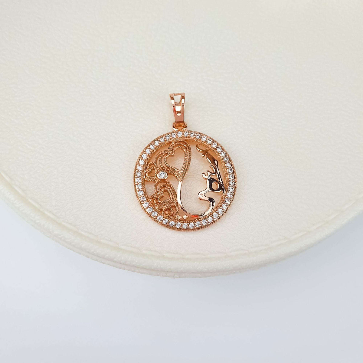 Pendant with a mother's profile and hearts on a cream jewellery box