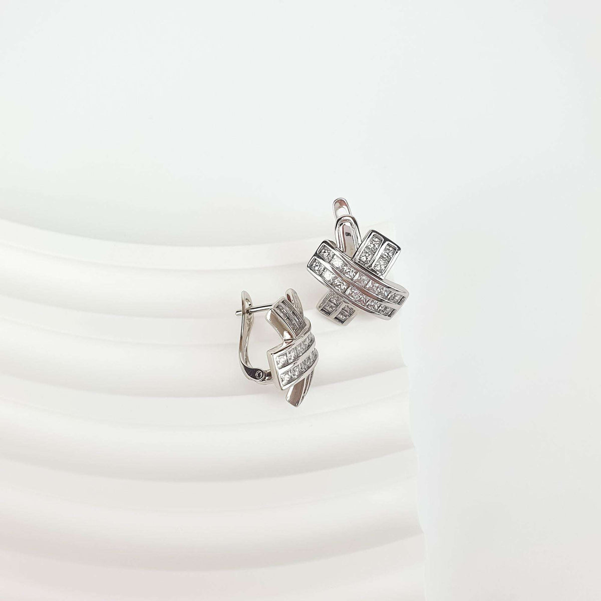 Side view of the earrings showing the leverback clasp and square stone rows