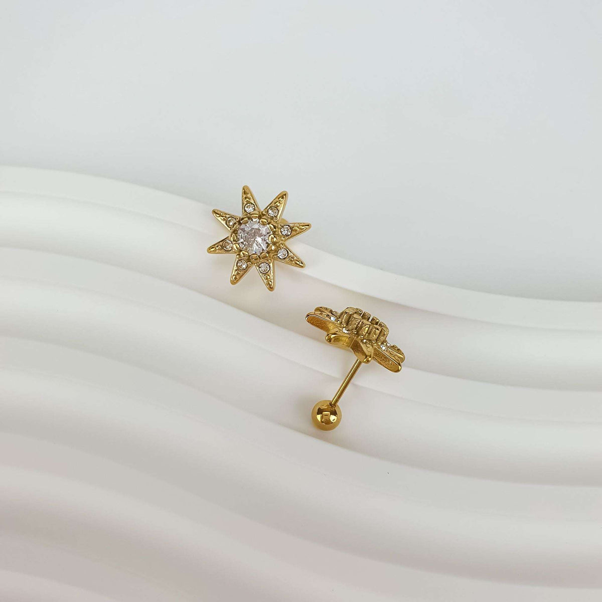 Gold-plated star earring shown front and back with a ball screw back