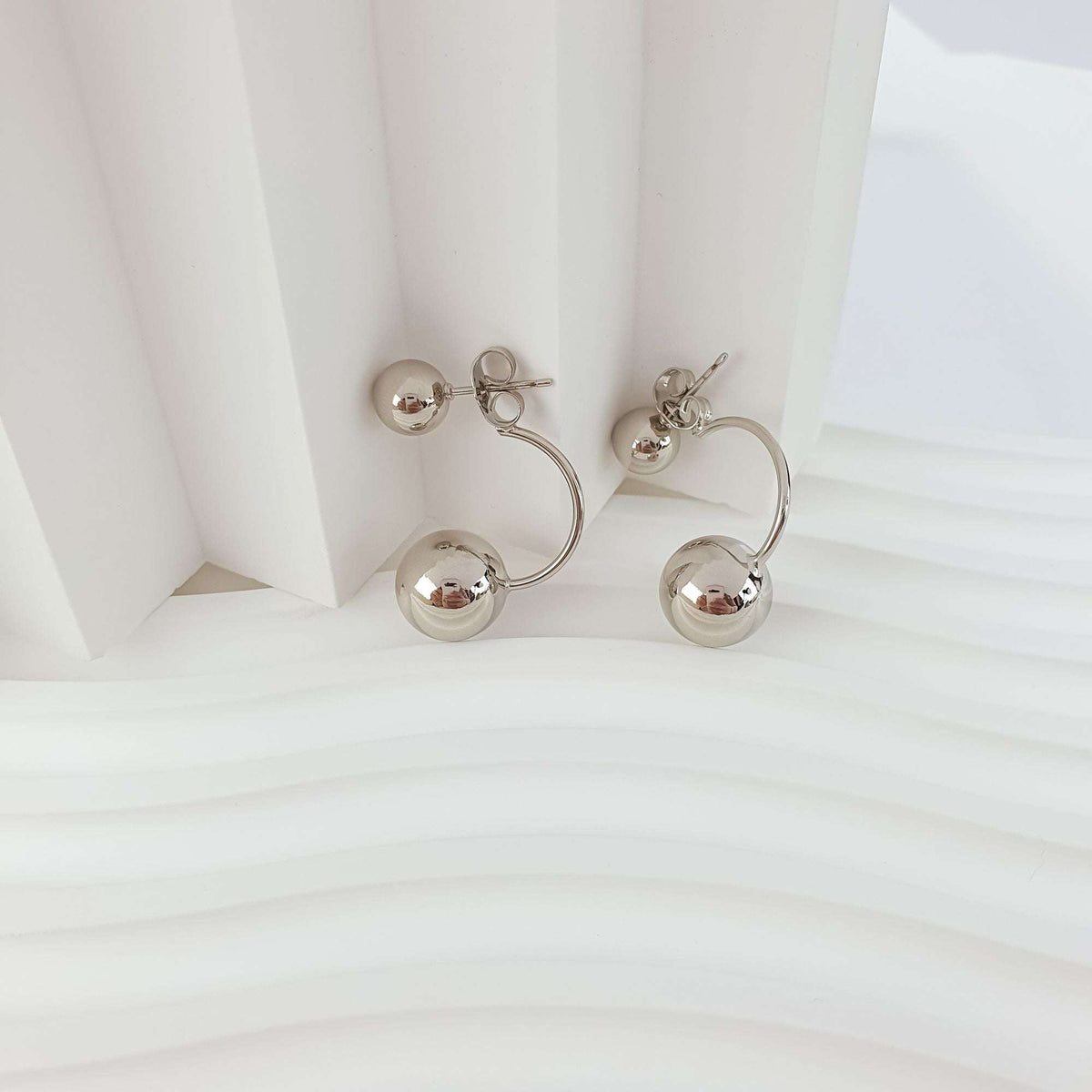 Side view of the earrings with push-back posts and shiny balls