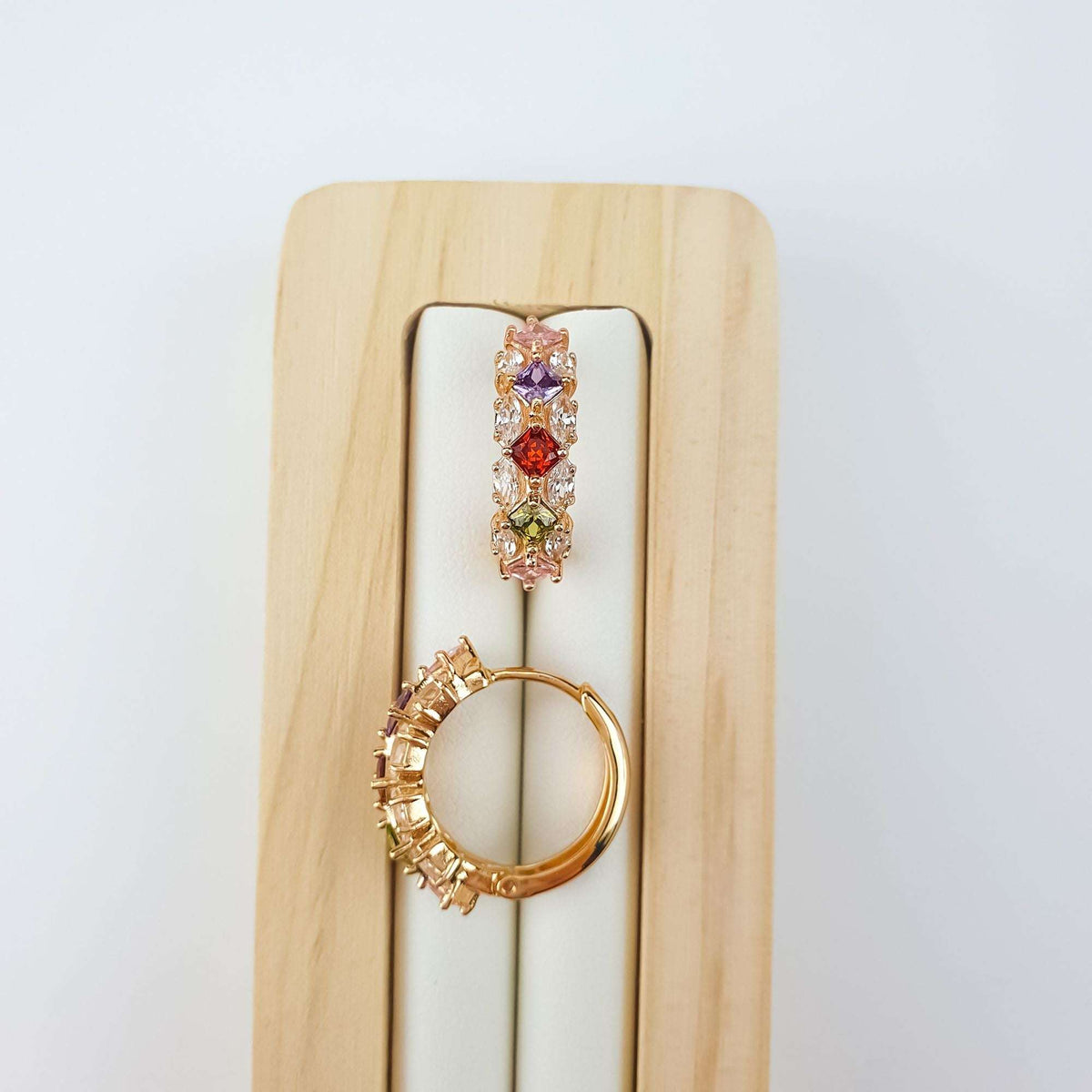 Multicolour | Row of colourful square stones on a wooden stand with gold-plated closure