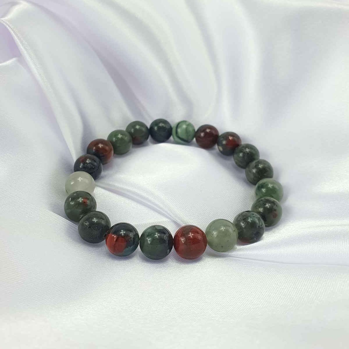 Natural bloodstone bracelet on white satin, vivid red and green contrast