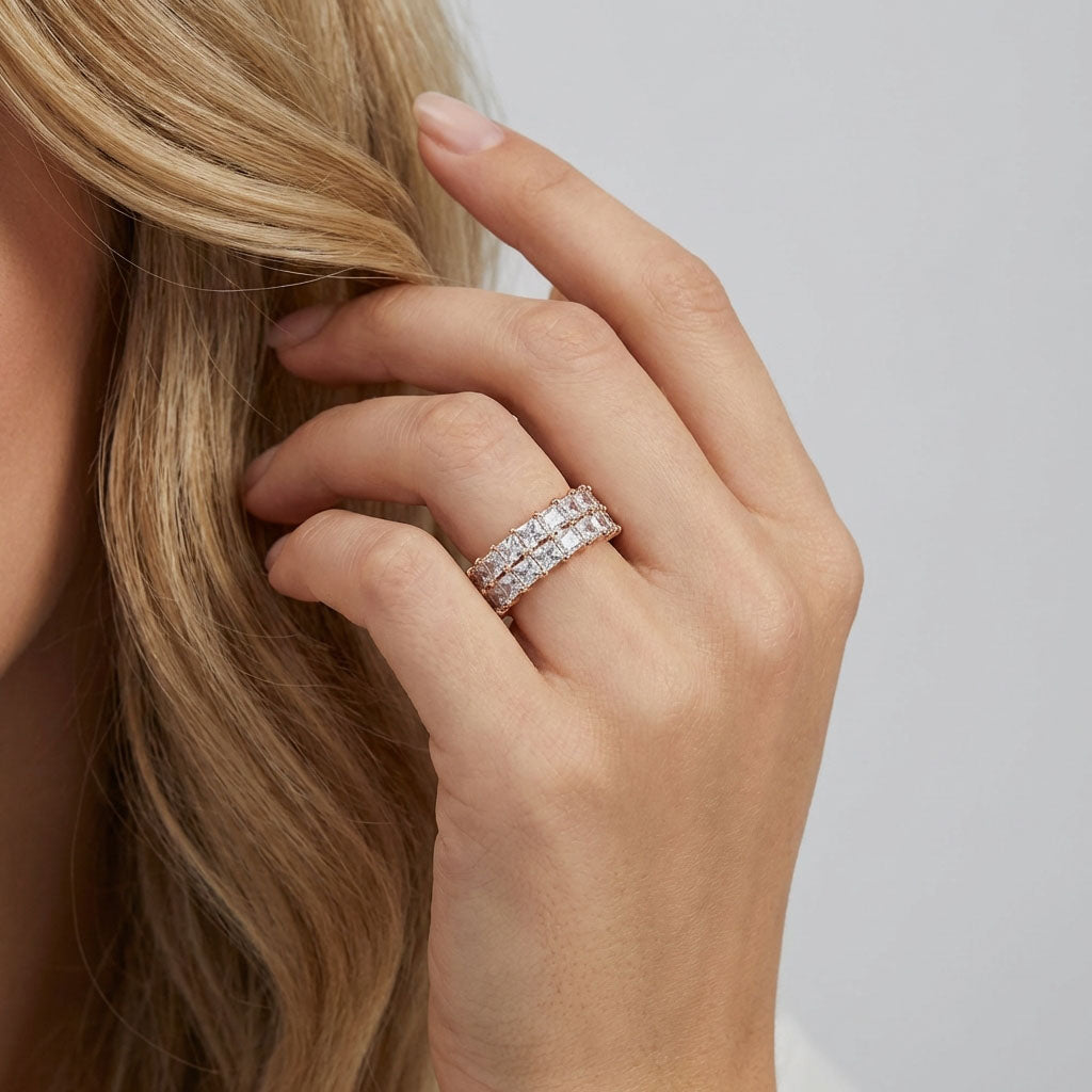 Blonde woman touching her hair, wearing a two-row cubic zirconia ring