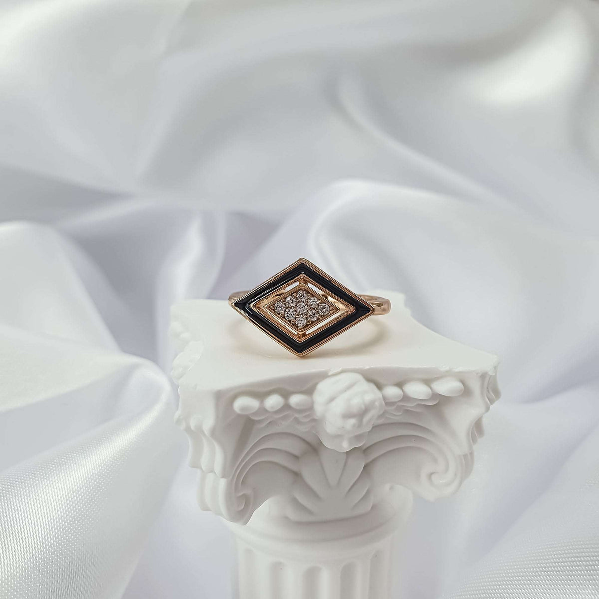 Rhombus ring with black enamel and a stone rosette on a white pedestal