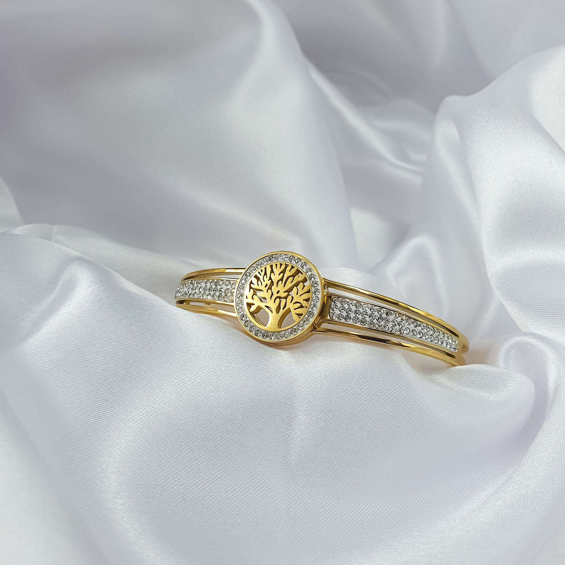 Tree of life bangle on white silk, stone bands sparkling in the light