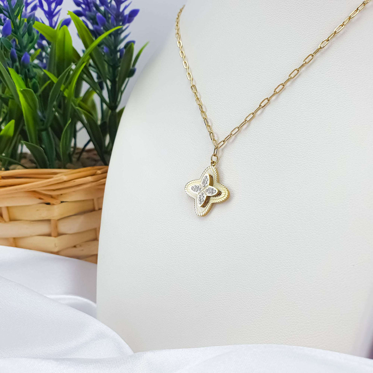 Four-leaf clover pendant with cubic zirconia on a gold-tone anchor chain, white bust