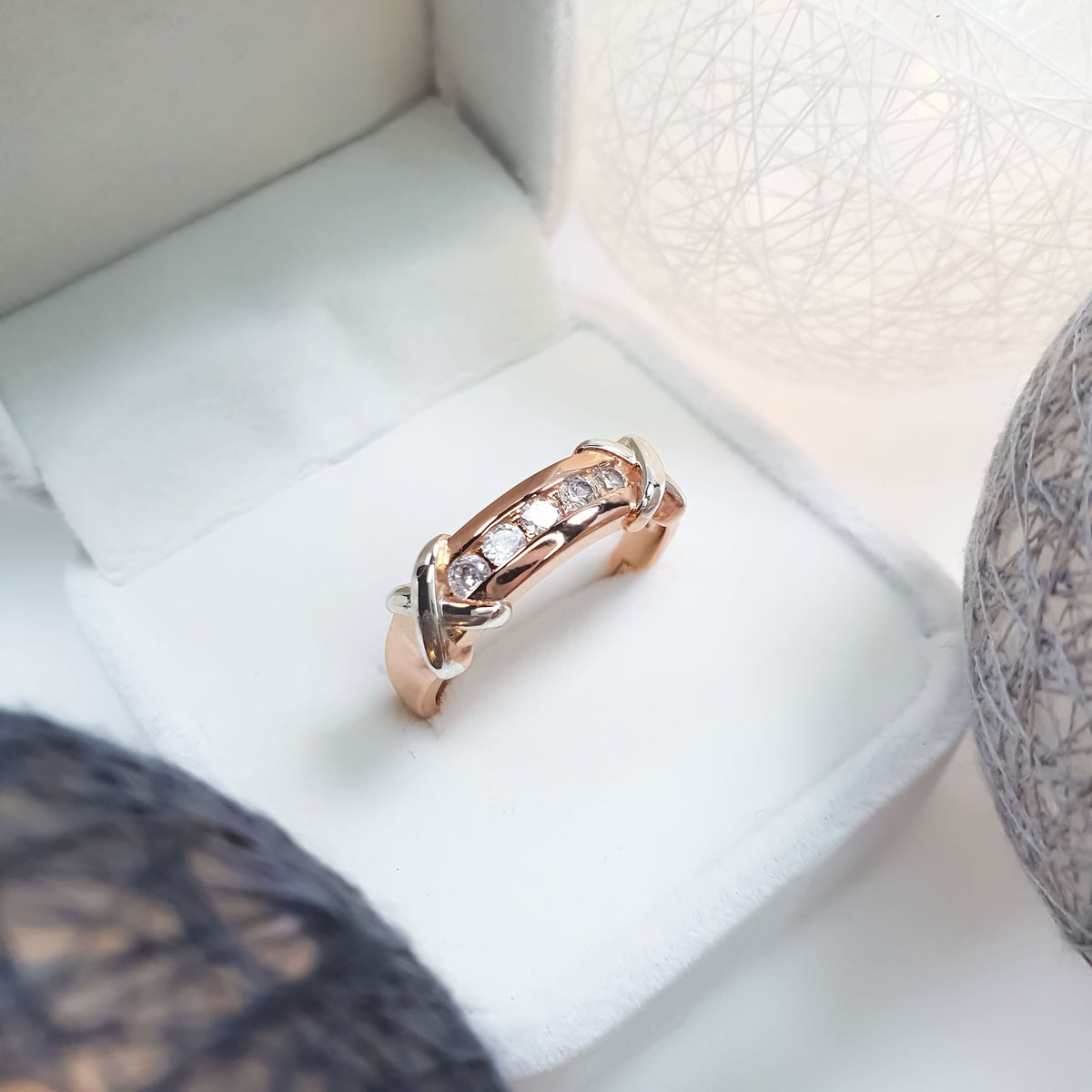 Ring with a row of cubic zirconia and silver-tone crosses in a gift box