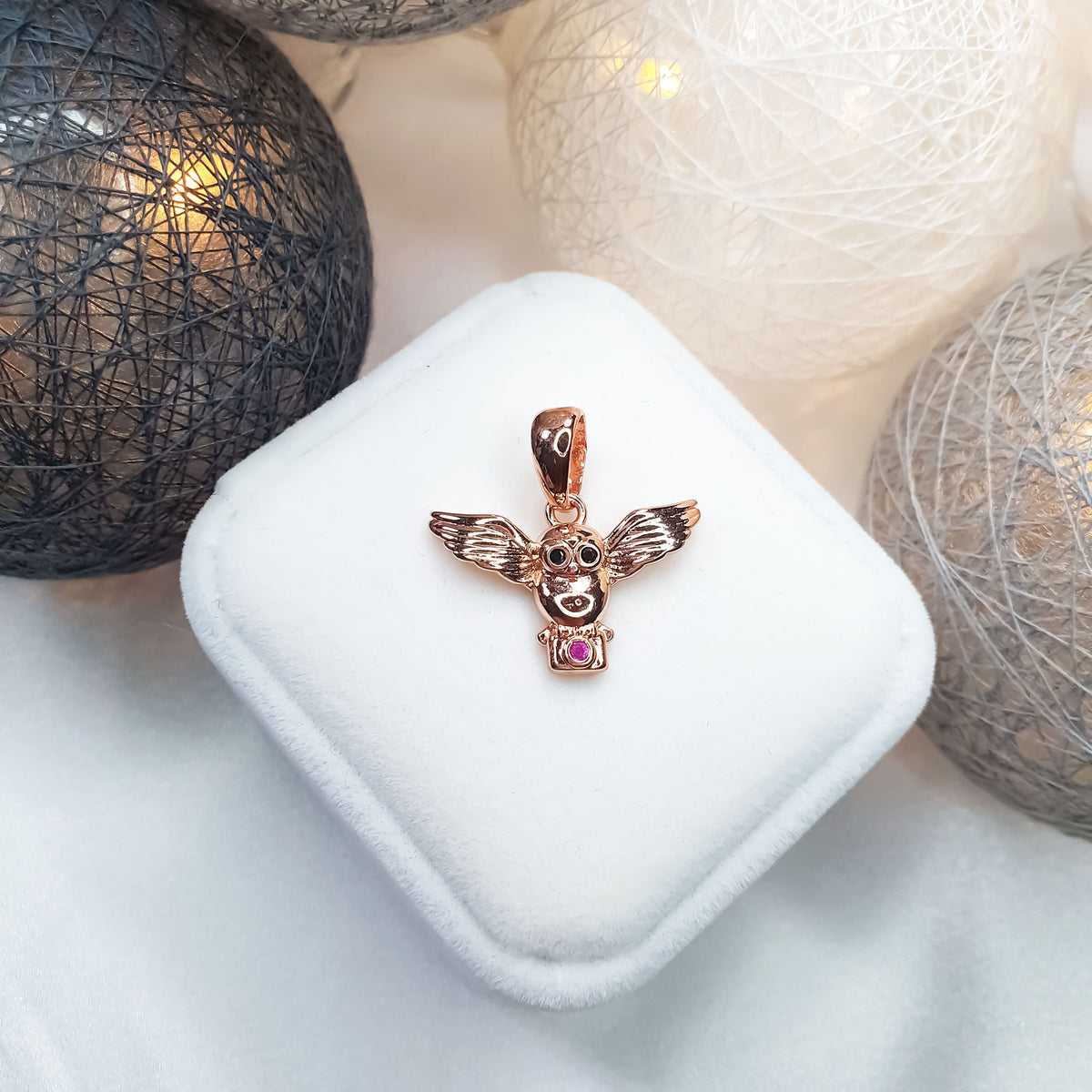 Winged owl pendant in a warm gold tone on a white box