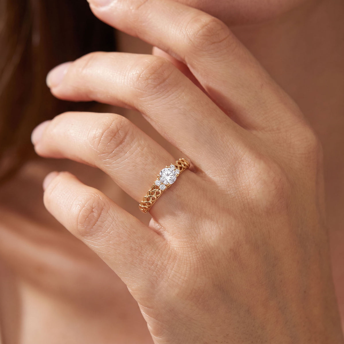 Gold-plated ring with a clear stone and a Celtic braided band