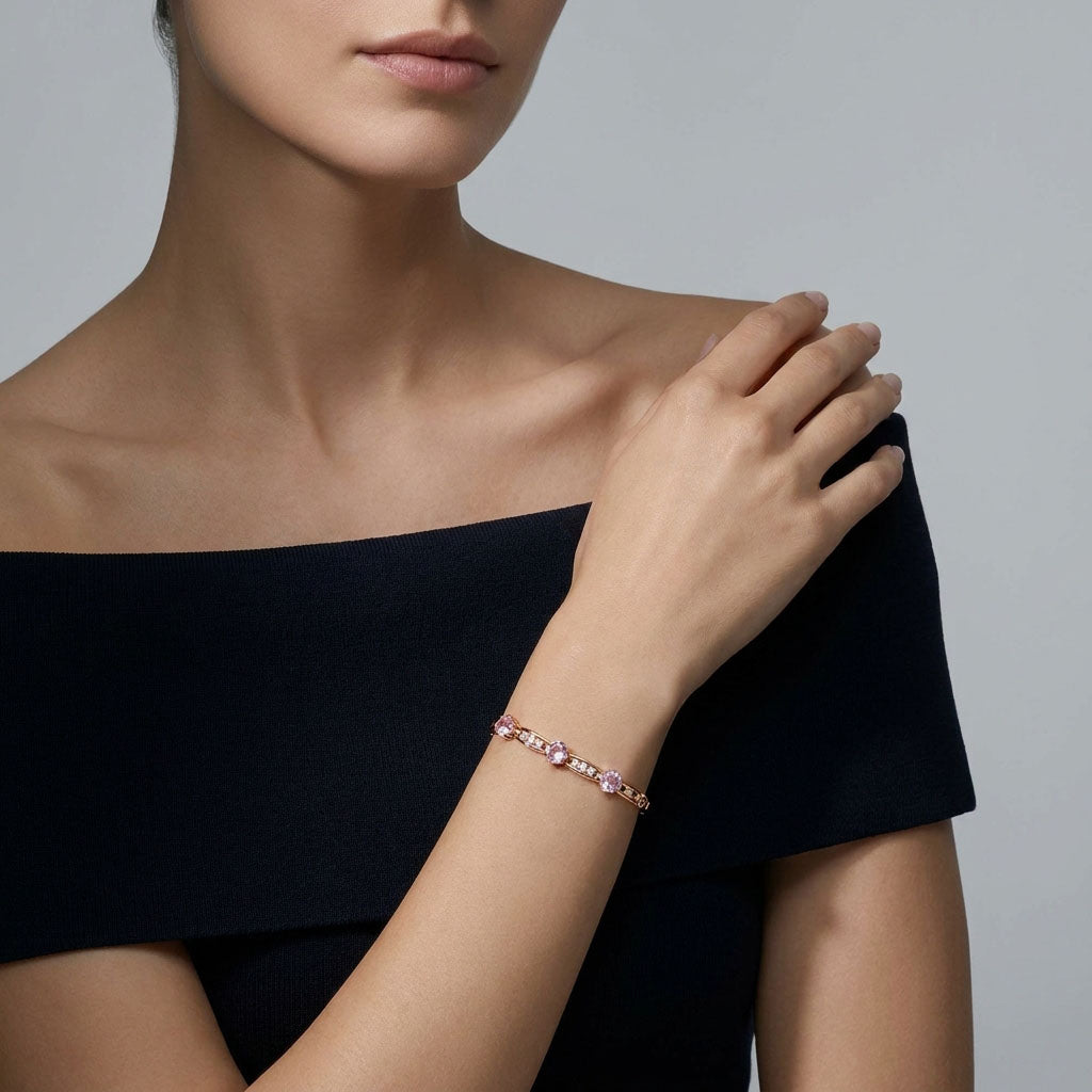 Model in a dark dress wearing the pink crystal gold-plated bracelet