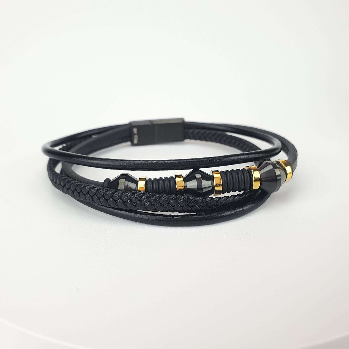 Men's layered bracelet in braided and smooth black faux leather with gold-tone steel details