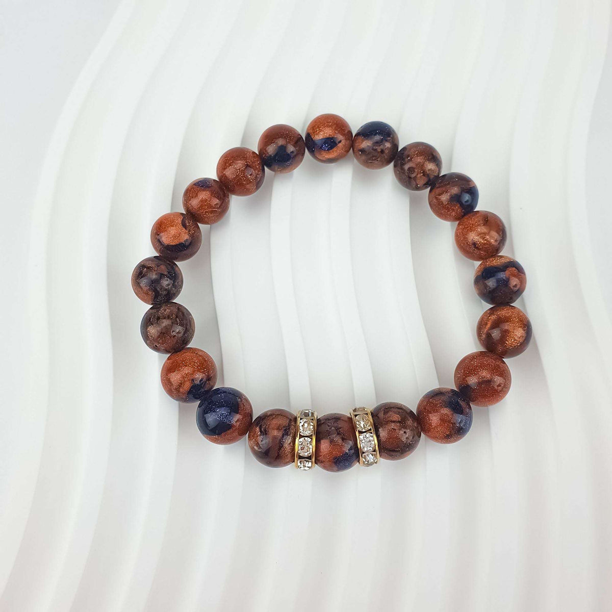 Close-up of glittering brown beads with two crystal spacers