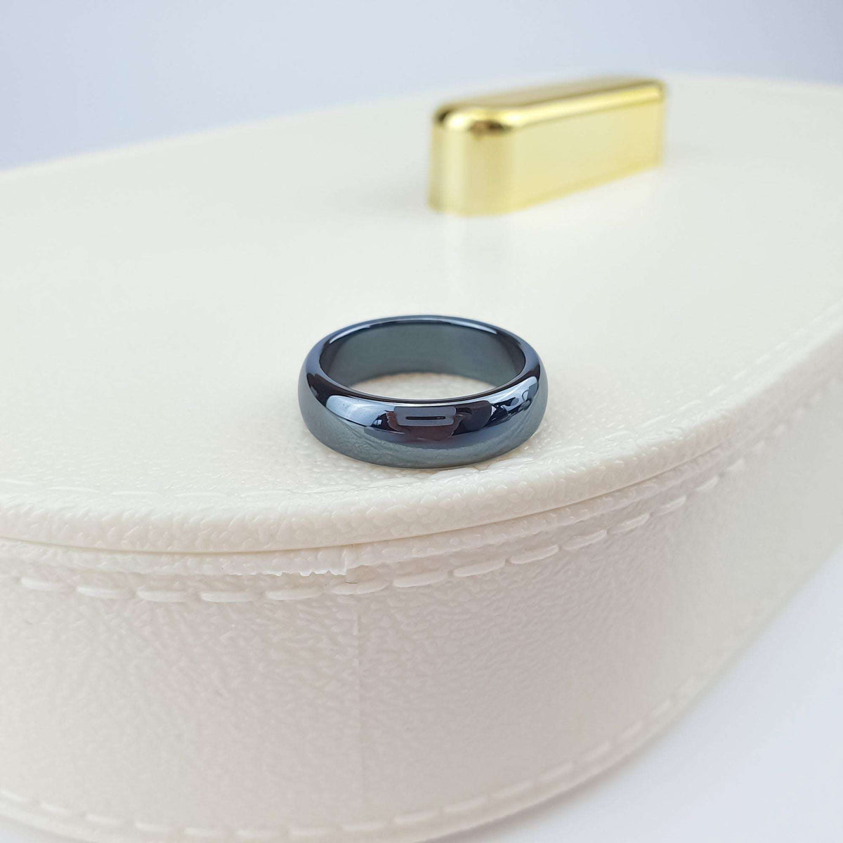 Close-up of a chunky hematite ring on a light jewellery box