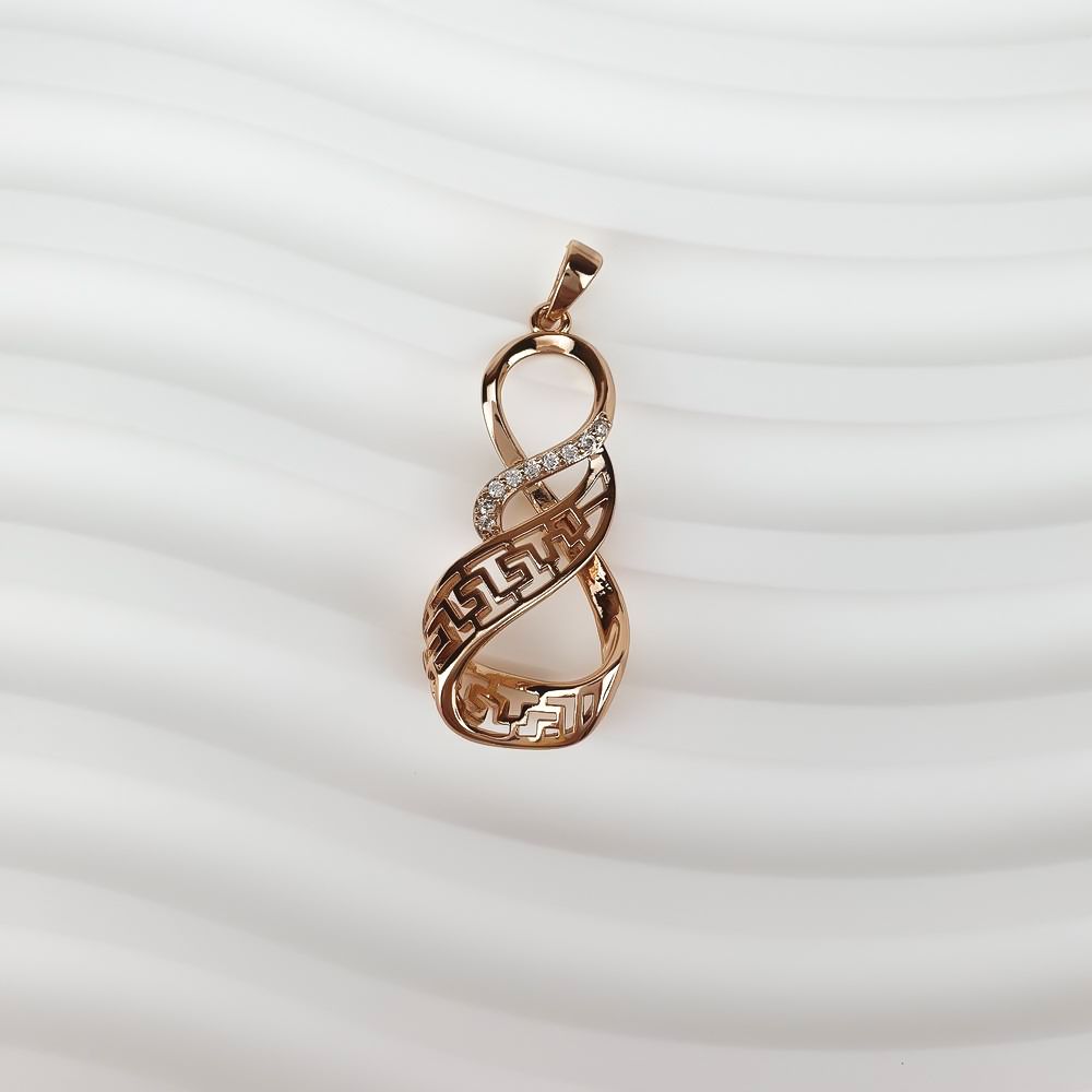 Side close-up of the gold-plated infinity pendant, sparkling stones and warm tone