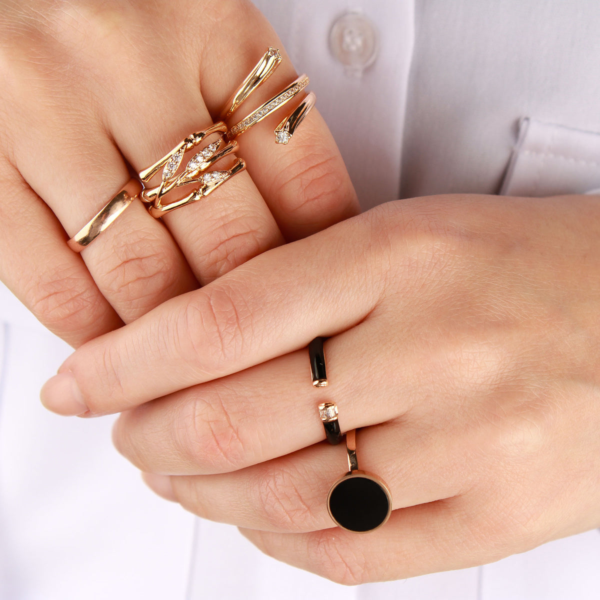 Spiral ring with tiny cubic zirconia on a model's finger with other jewellery