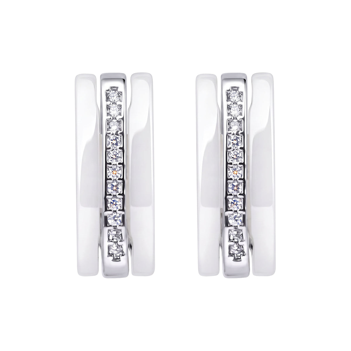 Close-up of white ceramic earrings with cubic zirconia in a silver-tone frame