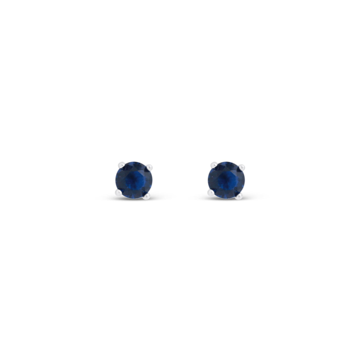 Dark sapphire blue crystals in shiny studs, close up on white