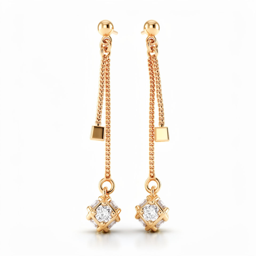 Long gold-tone earrings with two chains, a cube and a square-set clear stone