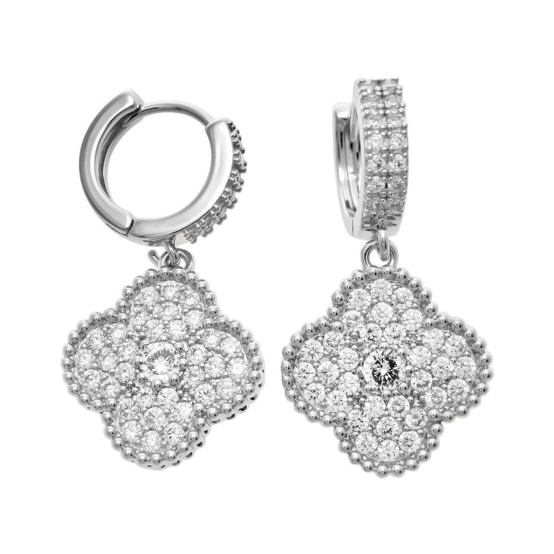 Silver-tone hoop earrings with a dangling clover fully covered in cubic zirconia