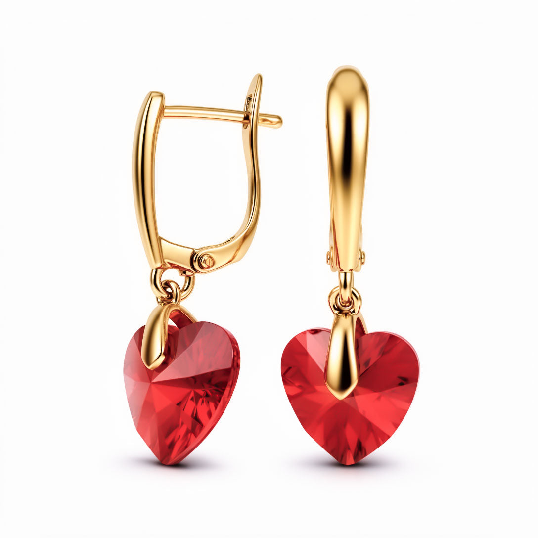 Gold-tone drop earrings with a bright red faceted crystal heart and secure clasp