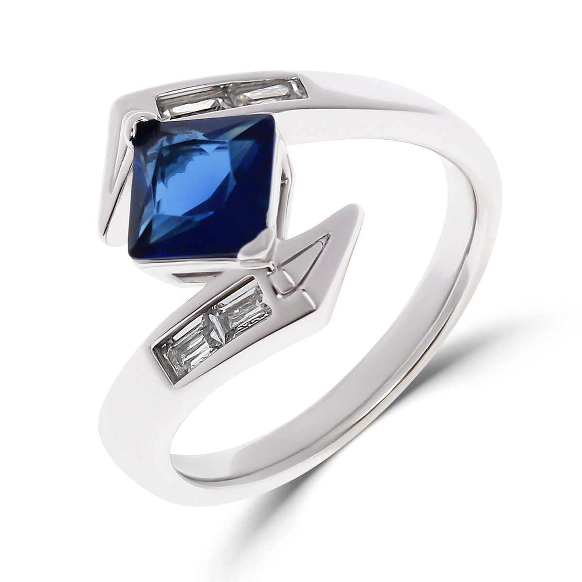 Asymmetric ring with a blue square stone and clear baguette stones at the sides