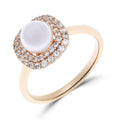 Gold-tone ring with a white pearl in a double cubic zirconia halo