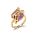 Gold-plated ring with an elongated pink stone in spiral beaded ribbons on white