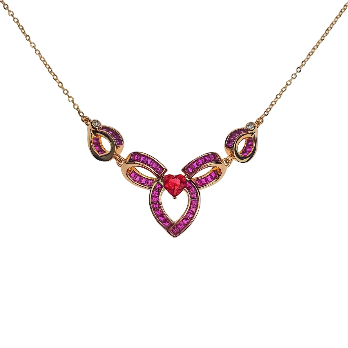 Gold-plated necklace with a red heart stone and loops of pink cubic zirconia
