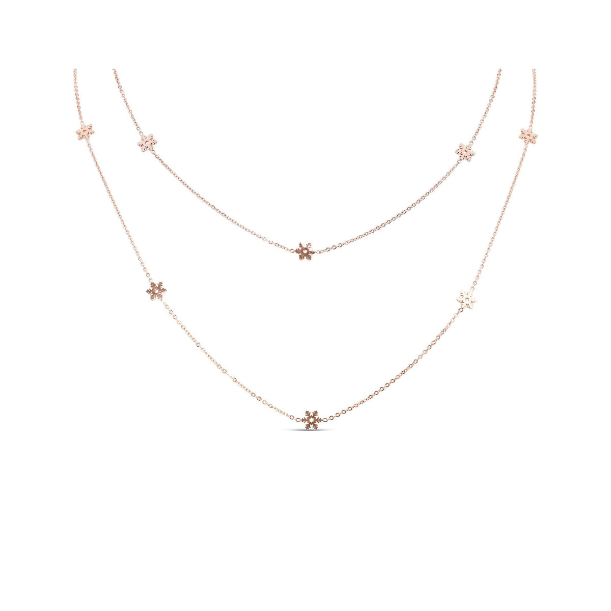 Rose gold-tone chain with small snowflakes, arranged in two loops on white