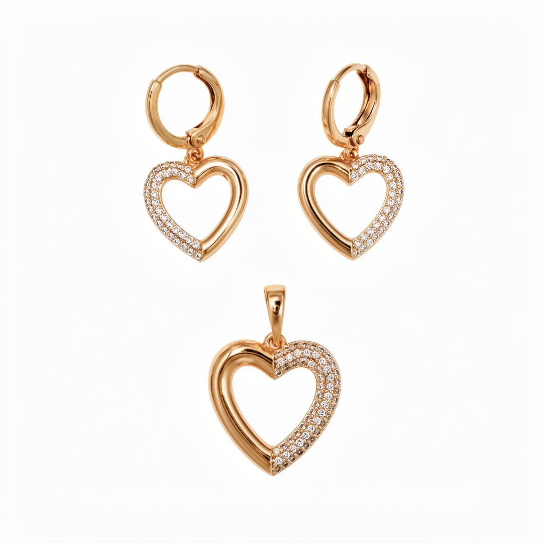 Heart pendant and earrings with cubic zirconia along one edge, in gold tone