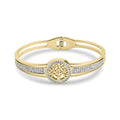 Rigid gold-tone bangle with a tree of life medallion and sparkling stone rows